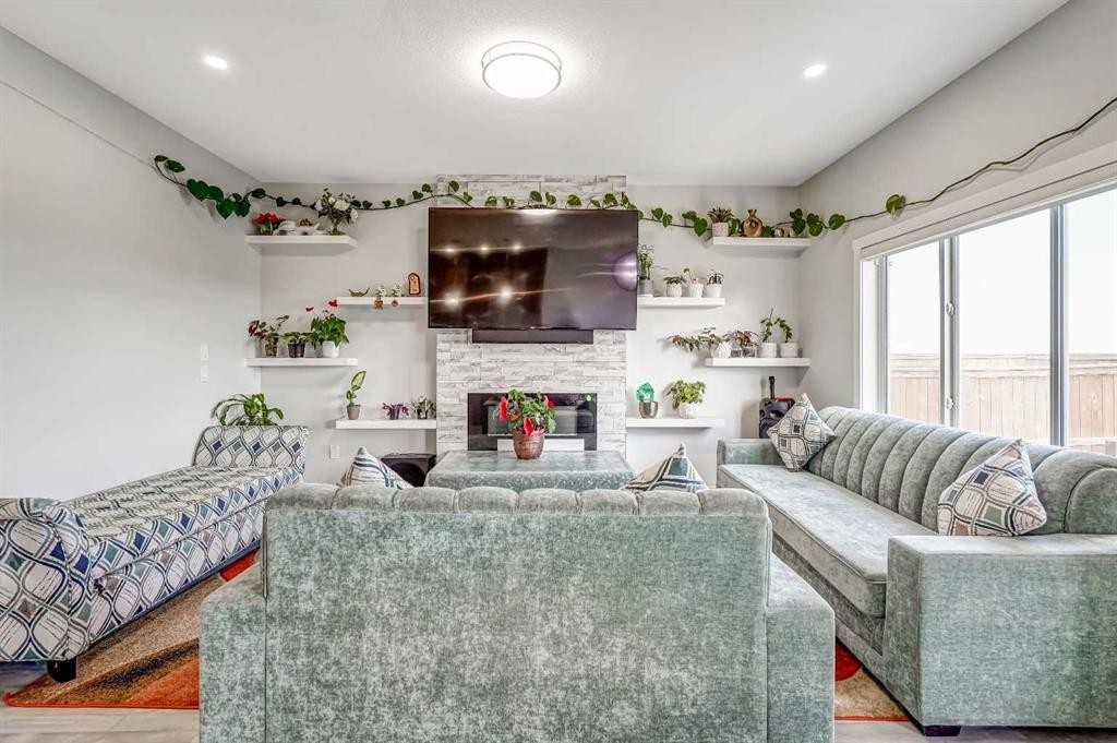 349 Corner Meadows Way Ne, Calgary, AB - Indoor Photo Showing Living Room With Fireplace