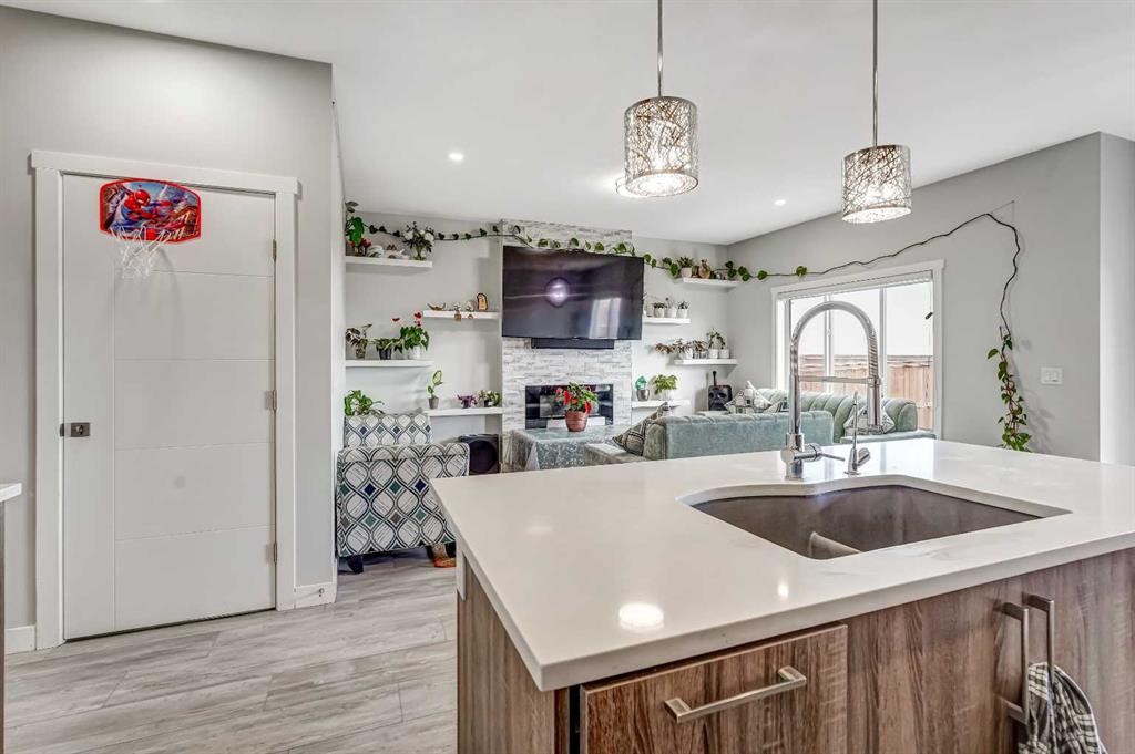 349 Corner Meadows Way Ne, Calgary, AB - Indoor Photo Showing Kitchen With Fireplace