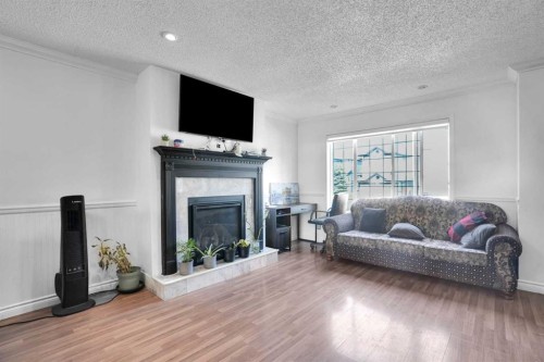 156 Saddlecrest Place Ne, Calgary, AB - Indoor Photo Showing Living Room With Fireplace