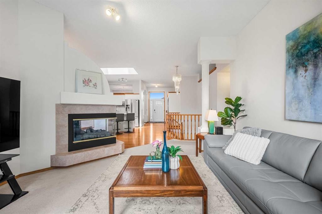 125 Woodpark Close Sw, Calgary, AB - Indoor Photo Showing Living Room With Fireplace