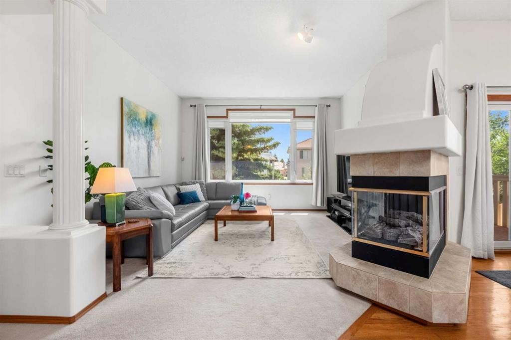 125 Woodpark Close Sw, Calgary, AB - Indoor Photo Showing Living Room With Fireplace
