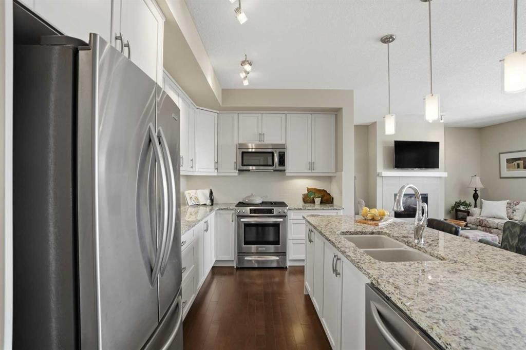 26 Cranbrook Villas Se, Calgary, AB - Indoor Photo Showing Kitchen With Stainless Steel Kitchen With Double Sink With Upgraded Kitchen