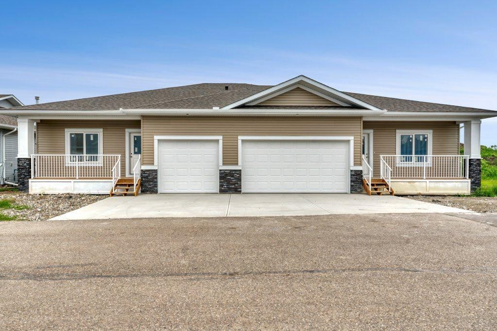 160 Ridgestone Lane, Diamond Valley, AB - Outdoor With Deck Patio Veranda With Facade