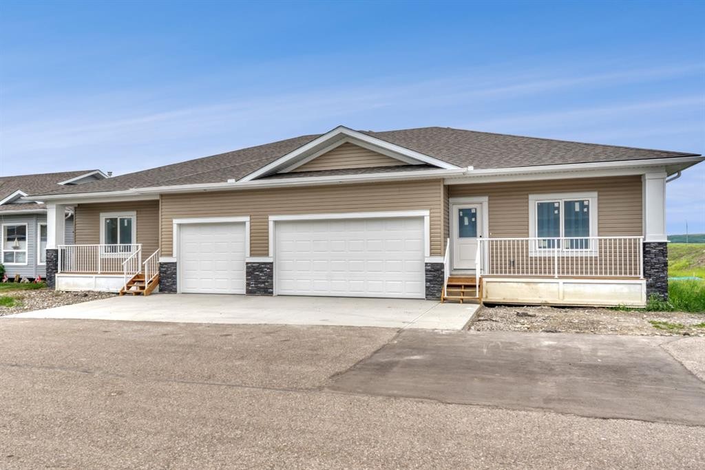 164 Ridgestone Lane, Diamond Valley, AB - Outdoor With Deck Patio Veranda With Facade