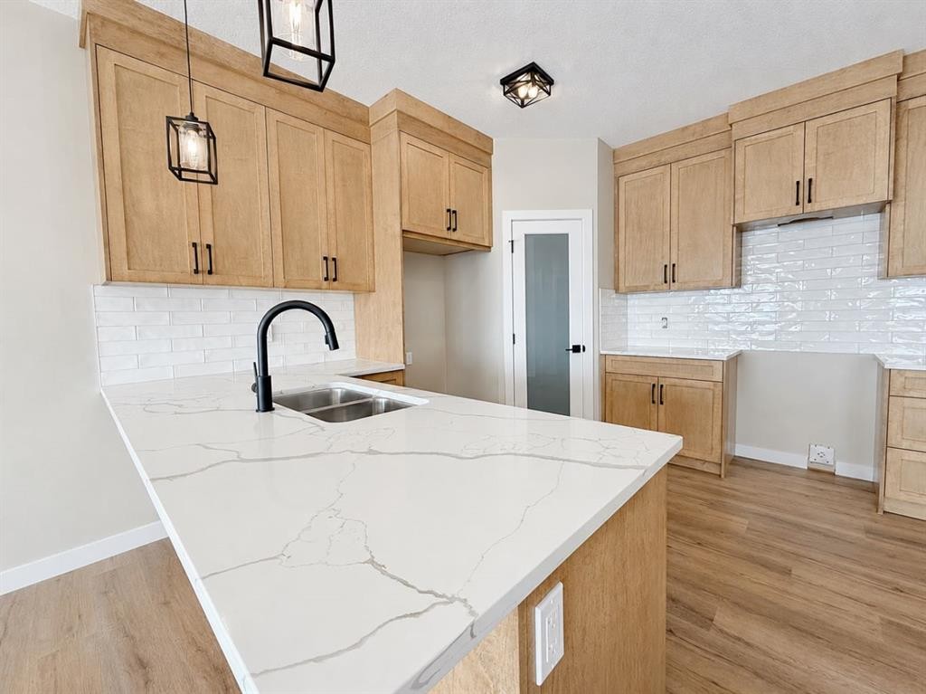 164 Ridgestone Lane, Diamond Valley, AB - Indoor Photo Showing Kitchen With Double Sink
