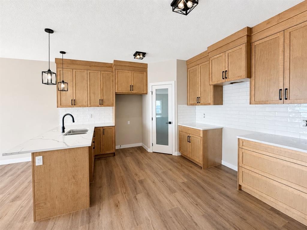 164 Ridgestone Lane, Diamond Valley, AB - Indoor Photo Showing Kitchen With Double Sink
