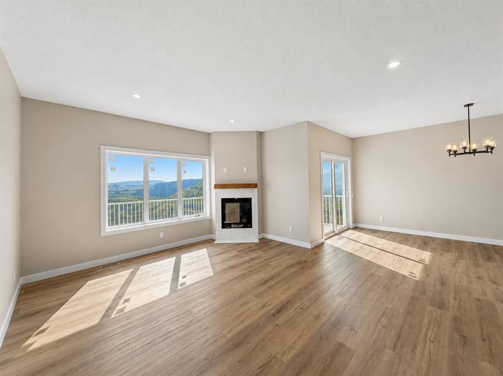 164 Ridgestone Lane, Diamond Valley, AB - Indoor With Fireplace
