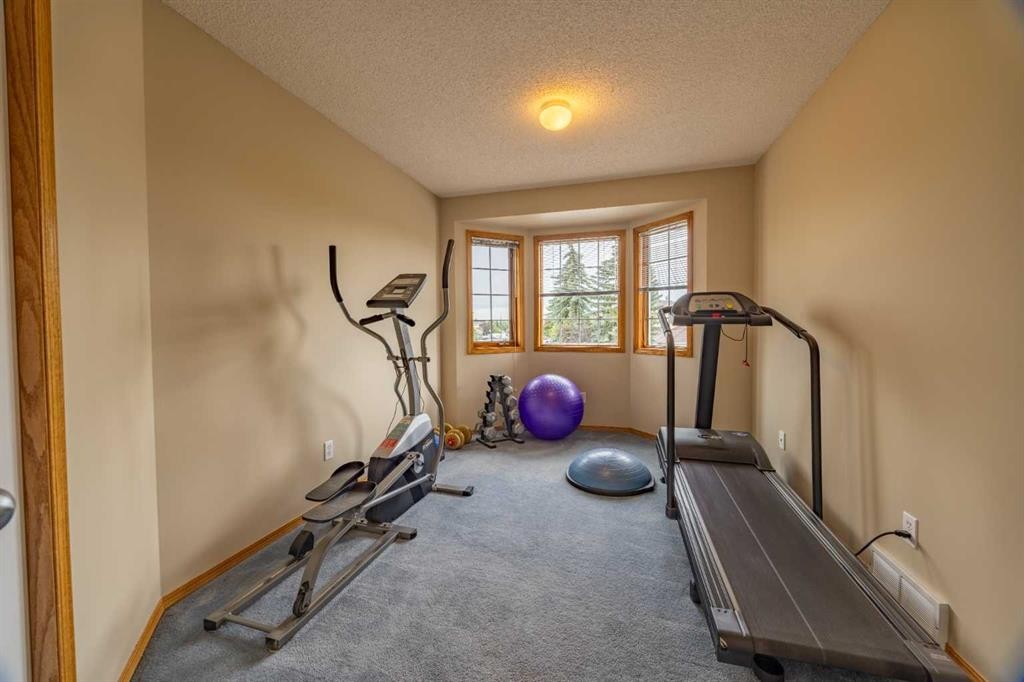 19 Mckenzie Lake Manor Se, Calgary, AB - Indoor Photo Showing Gym Room