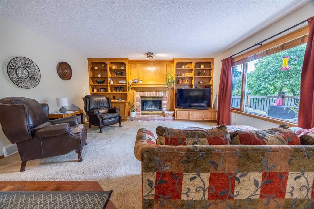 19 Mckenzie Lake Manor Se, Calgary, AB - Indoor Photo Showing Living Room With Fireplace