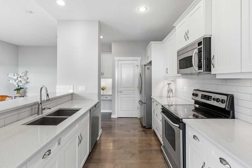122 Ypres Green Sw, Calgary, AB - Indoor Photo Showing Kitchen With Stainless Steel Kitchen With Double Sink With Upgraded Kitchen