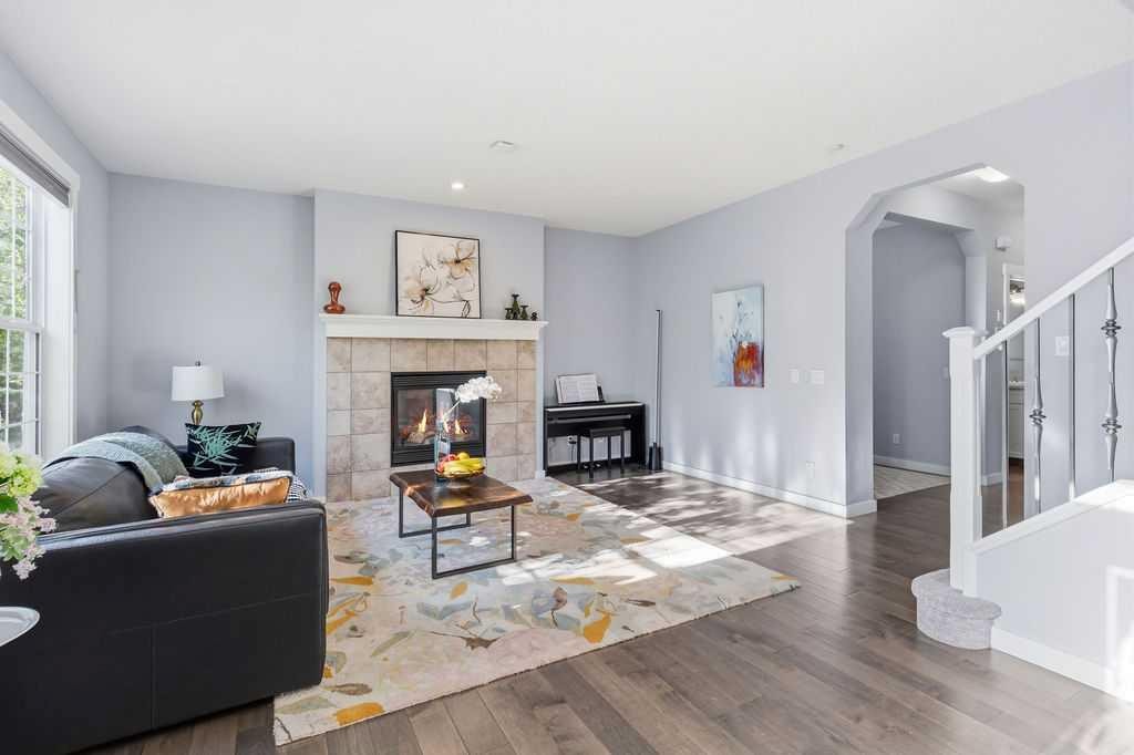 122 Ypres Green Sw, Calgary, AB - Indoor Photo Showing Living Room With Fireplace