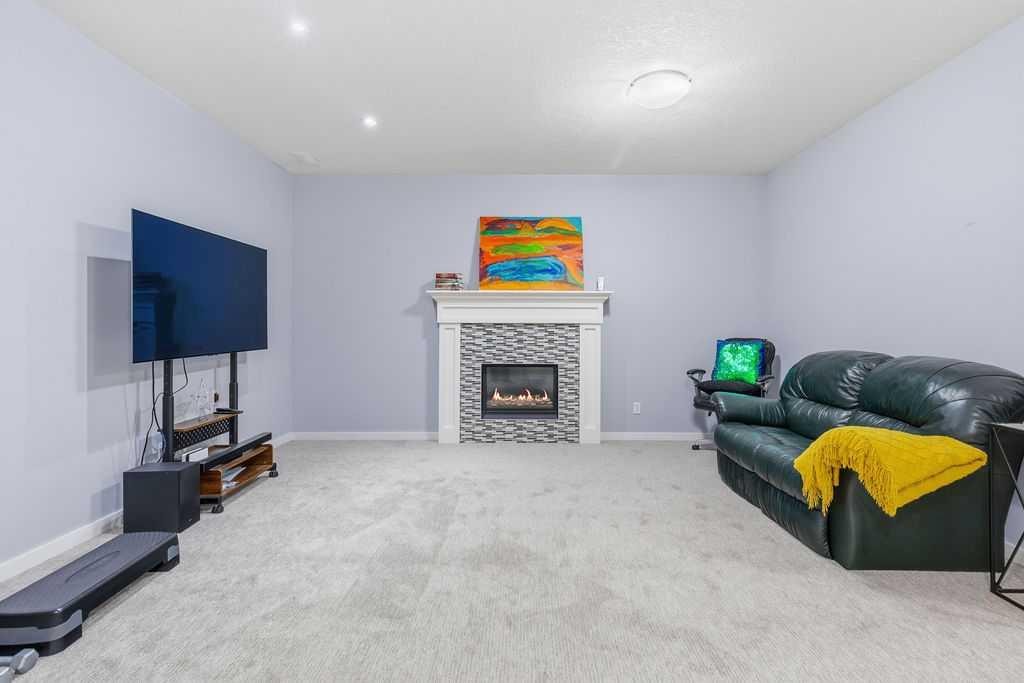 122 Ypres Green Sw, Calgary, AB - Indoor With Fireplace