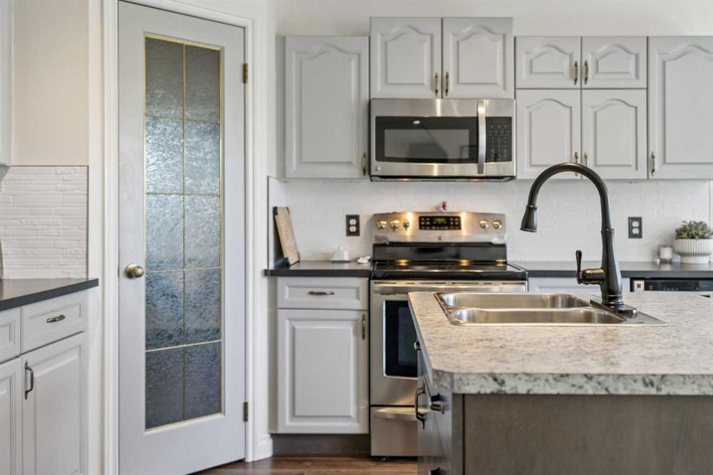 52 West Edge Road, Cochrane, AB - Indoor Photo Showing Kitchen With Stainless Steel Kitchen With Double Sink With Upgraded Kitchen