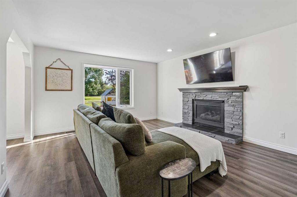52 West Edge Road, Cochrane, AB - Indoor Photo Showing Living Room With Fireplace