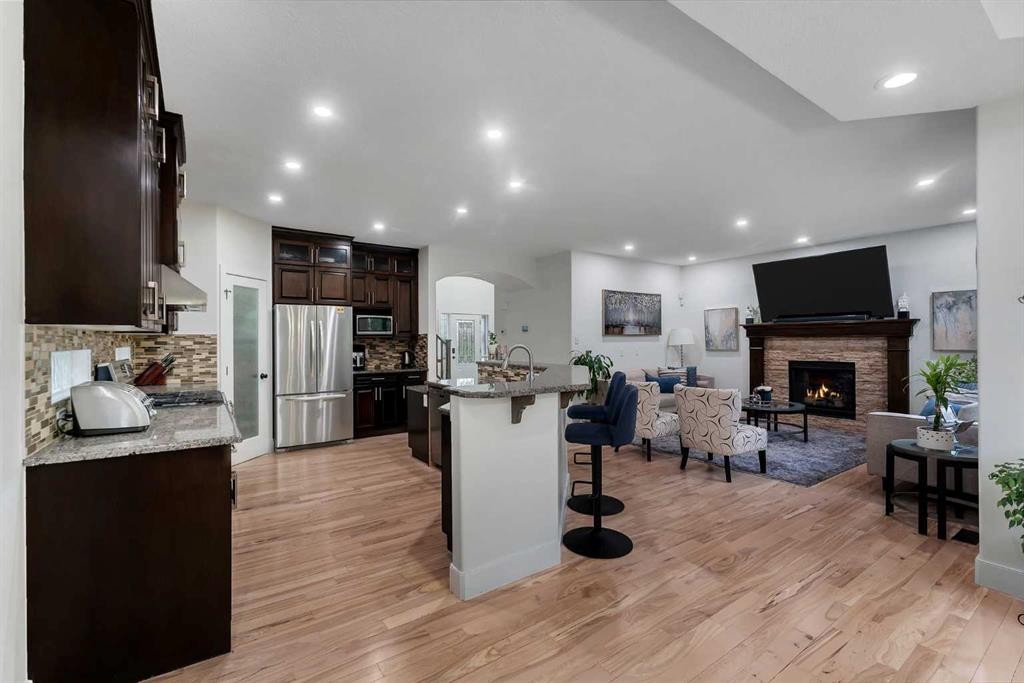 109 Evanscove Heights Nw, Calgary, AB - Indoor Photo Showing Kitchen With Fireplace