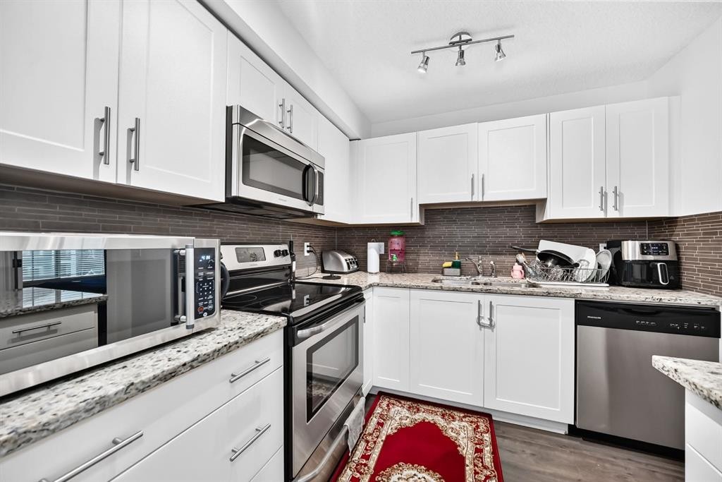 4310-755 Copperpond Boulevard Se, Calgary, AB - Indoor Photo Showing Kitchen With Double Sink