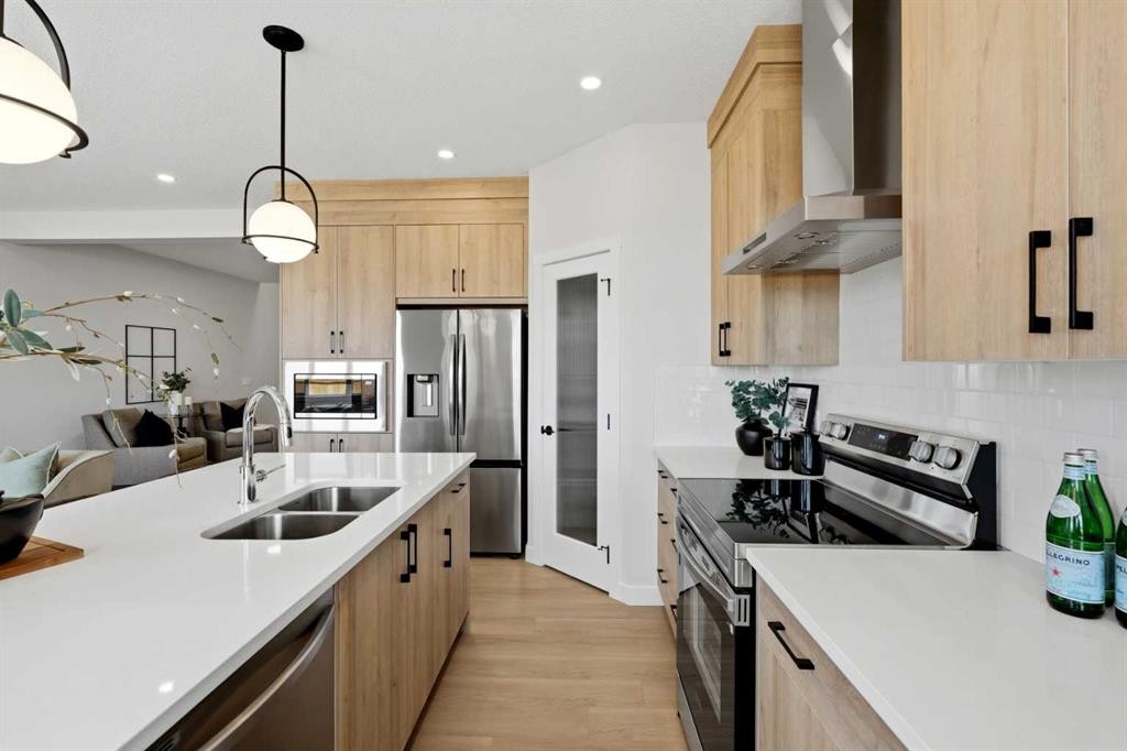 695 Buffaloberry Manor Se, Calgary, AB - Indoor Photo Showing Kitchen With Stainless Steel Kitchen With Double Sink With Upgraded Kitchen