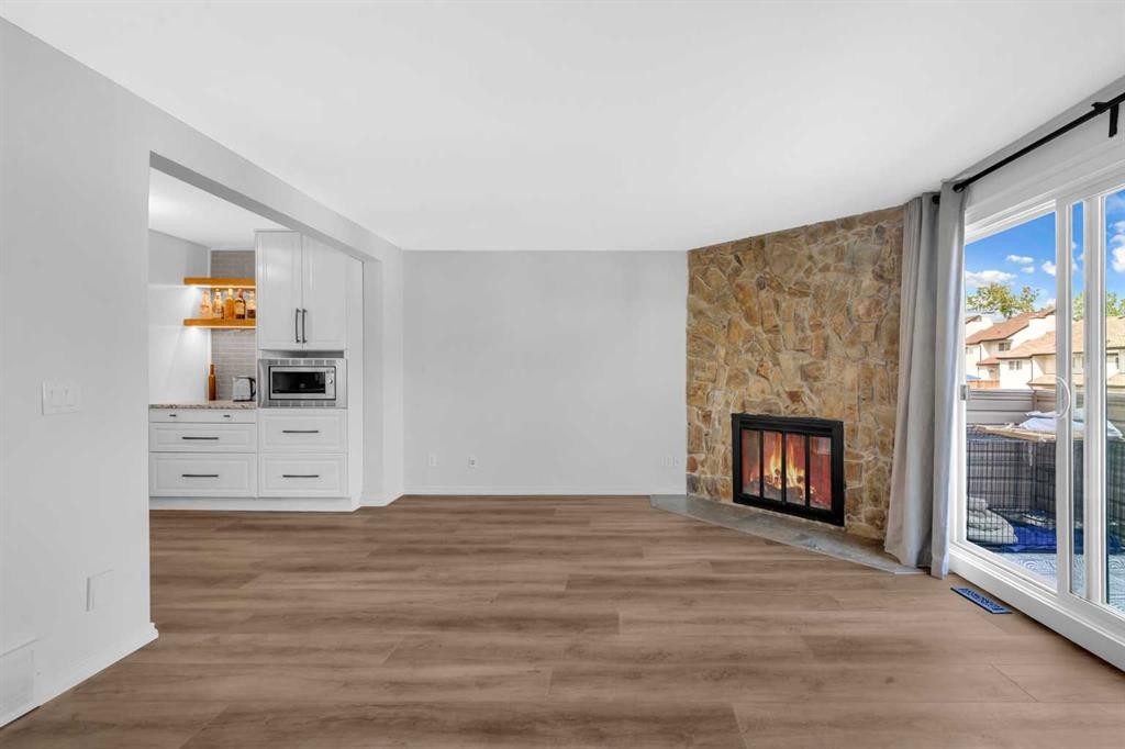 15 Ranch Glen Drive Nw, Calgary, AB - Indoor Photo Showing Living Room With Fireplace