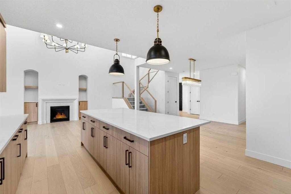 539 Waterford Rise, Chestermere, AB - Indoor Photo Showing Kitchen With Fireplace