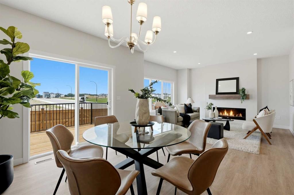7 Verdure Gate Sw, Calgary, AB - Indoor Photo Showing Dining Room With Fireplace