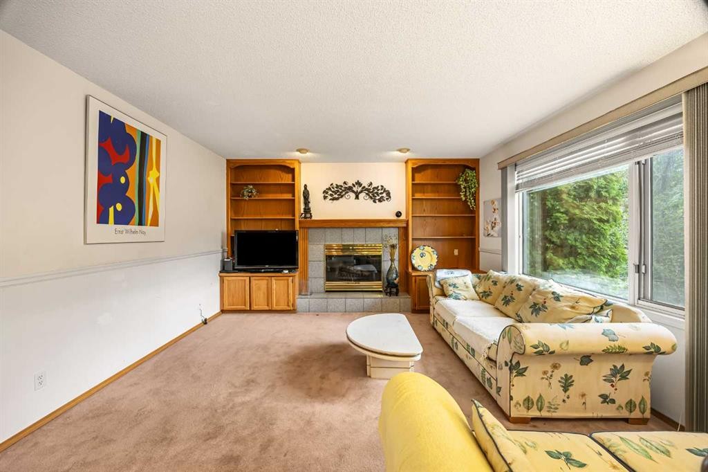 107 Hampshire Close Nw, Calgary, AB - Indoor Photo Showing Other Room With Fireplace