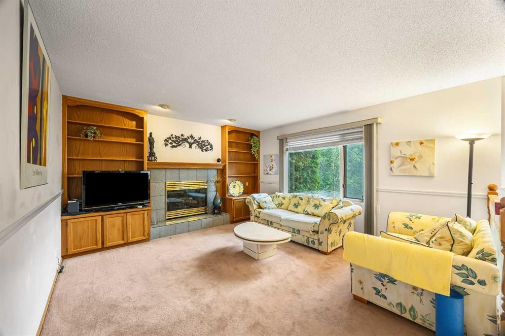 107 Hampshire Close Nw, Calgary, AB - Indoor Photo Showing Living Room With Fireplace