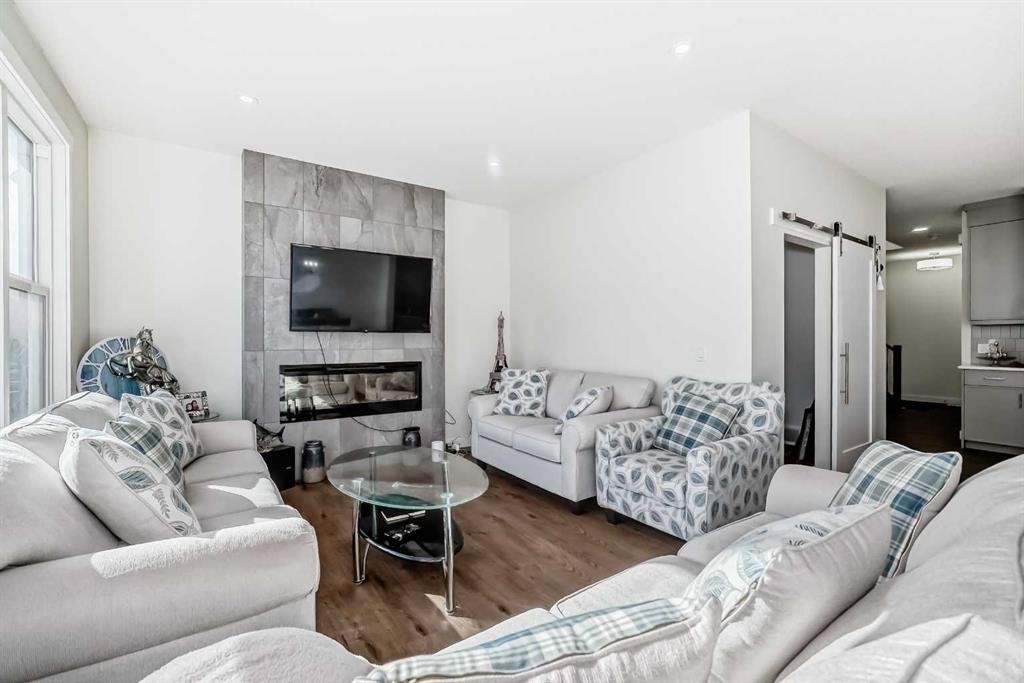 138 Silver Spruce Grove Sw, Calgary, AB - Indoor Photo Showing Living Room With Fireplace
