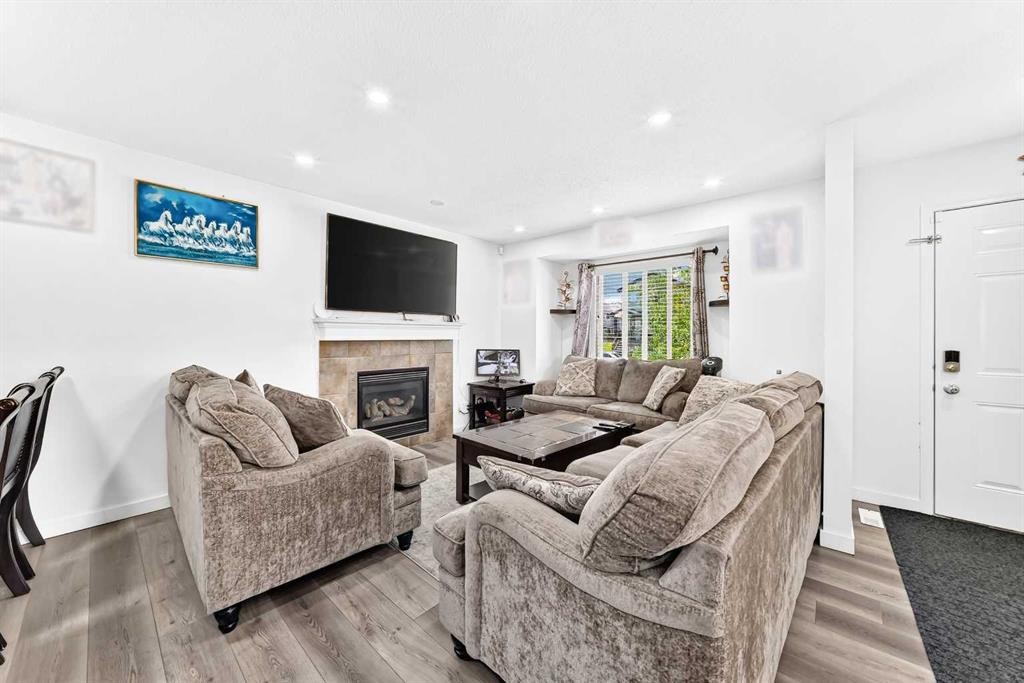 24 Taralake Road Ne, Calgary, AB - Indoor Photo Showing Living Room With Fireplace