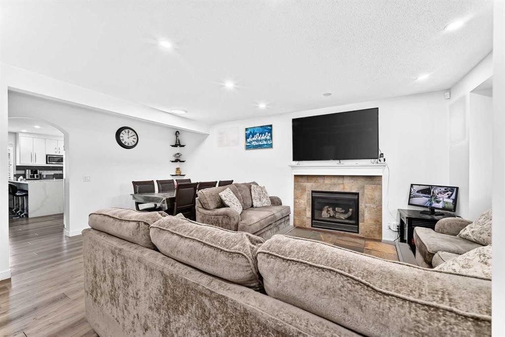 24 Taralake Road Ne, Calgary, AB - Indoor Photo Showing Other Room With Fireplace