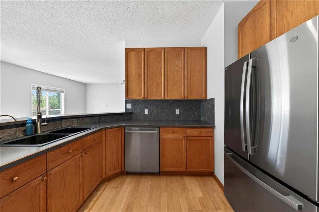 18 Cougarstone Bay Sw, Calgary, AB - Indoor Photo Showing Kitchen With Double Sink