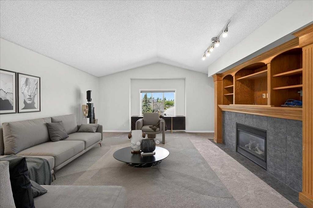 18 Cougarstone Bay Sw, Calgary, AB - Indoor Photo Showing Living Room With Fireplace