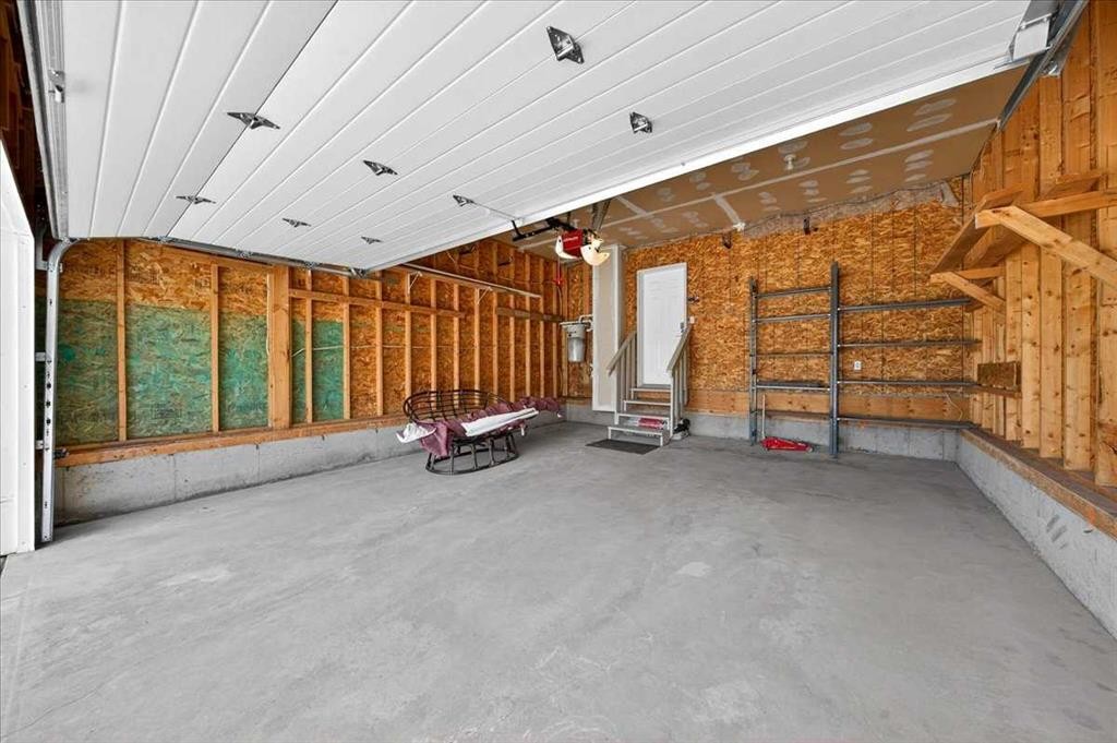 18 Cougarstone Bay Sw, Calgary, AB - Indoor Photo Showing Garage