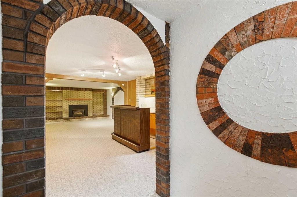 47 Montrose Crescent Ne, Calgary, AB - Indoor Photo Showing Other Room With Fireplace