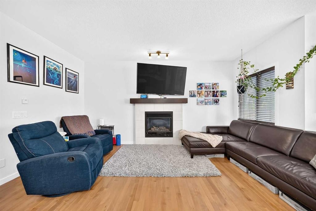 16 Sunrise Crescent, Cochrane, AB - Indoor Photo Showing Living Room With Fireplace