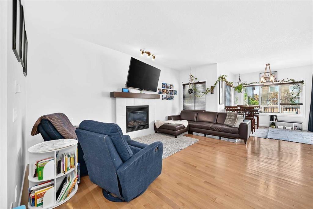 16 Sunrise Crescent, Cochrane, AB - Indoor Photo Showing Living Room With Fireplace