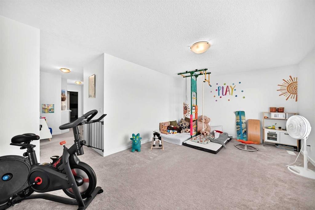 16 Sunrise Crescent, Cochrane, AB - Indoor Photo Showing Gym Room