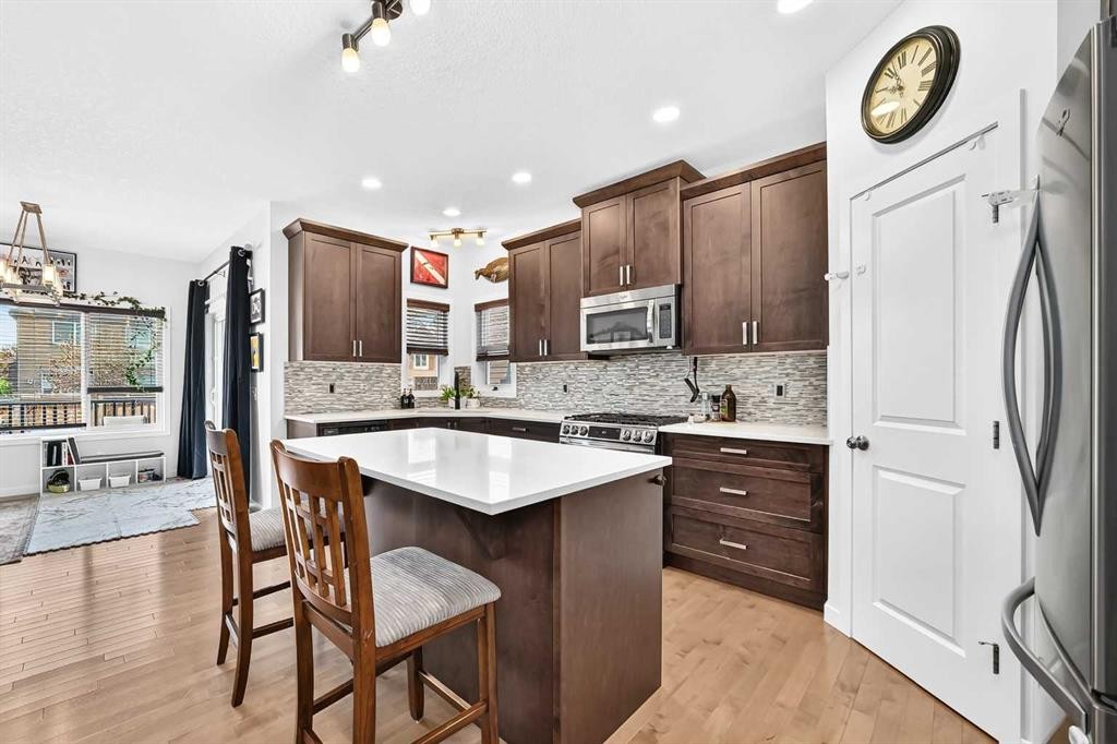 16 Sunrise Crescent, Cochrane, AB - Indoor Photo Showing Kitchen With Upgraded Kitchen