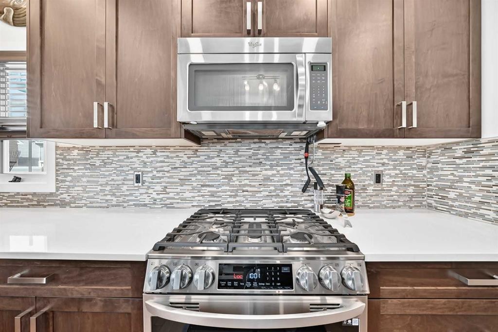 16 Sunrise Crescent, Cochrane, AB - Indoor Photo Showing Kitchen With Upgraded Kitchen