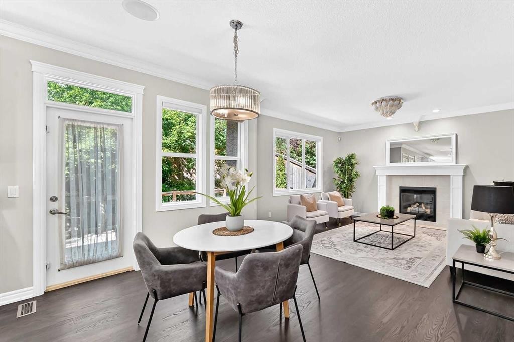 173 Aspenshire Drive Sw, Calgary, AB - Indoor Photo Showing Dining Room With Fireplace