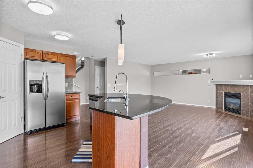 140 West Creek Circle, Chestermere, AB - Indoor Photo Showing Kitchen With Fireplace