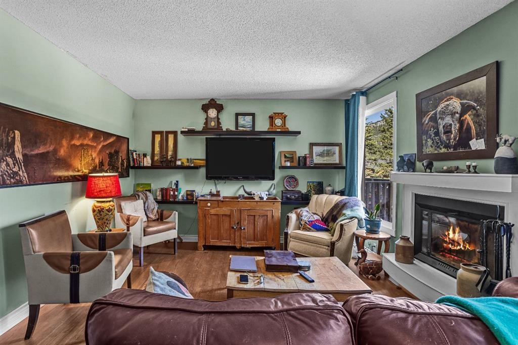 246 Kluane Drive, Banff, AB - Indoor Photo Showing Living Room With Fireplace