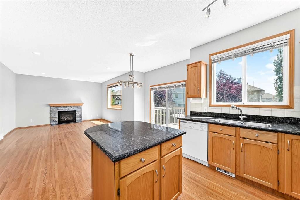 83 Edgeridge Close Nw, Calgary, AB - Indoor Photo Showing Kitchen With Fireplace With Double Sink