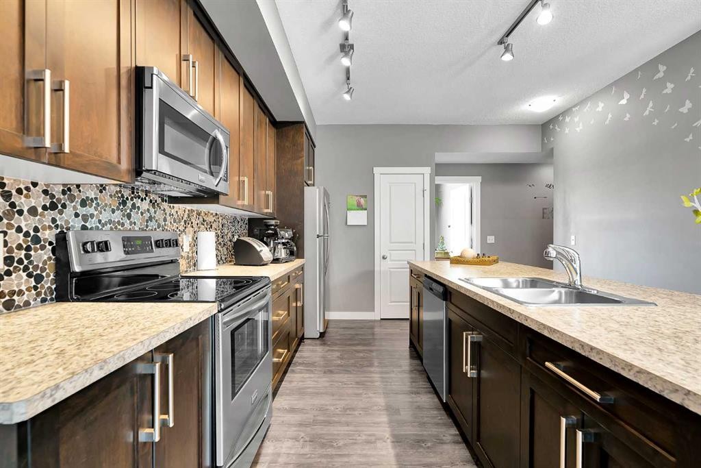 410 Cranford Walk Se, Calgary, AB - Indoor Photo Showing Kitchen With Double Sink With Upgraded Kitchen