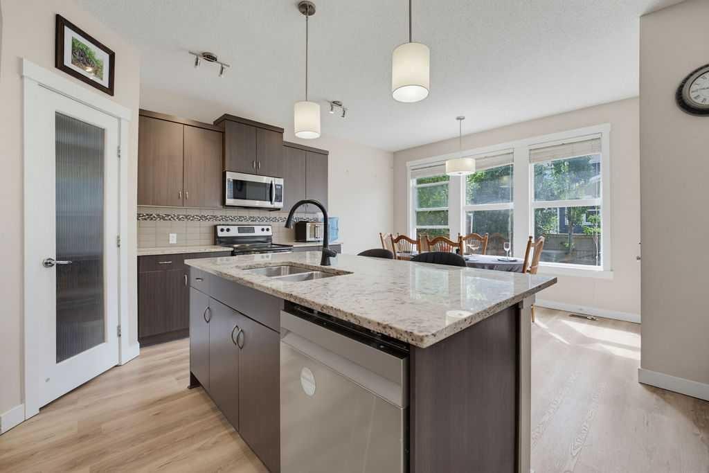 145 Sunset Manor, Cochrane, AB - Indoor Photo Showing Kitchen With Double Sink With Upgraded Kitchen