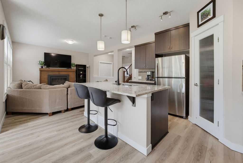 145 Sunset Manor, Cochrane, AB - Indoor Photo Showing Kitchen With Stainless Steel Kitchen With Upgraded Kitchen