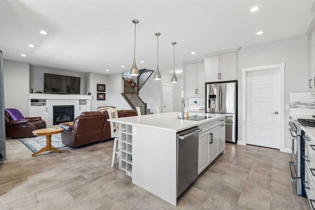 7 Bishop Circle, Carstairs, AB - Indoor Photo Showing Kitchen With Fireplace With Stainless Steel Kitchen With Upgraded Kitchen