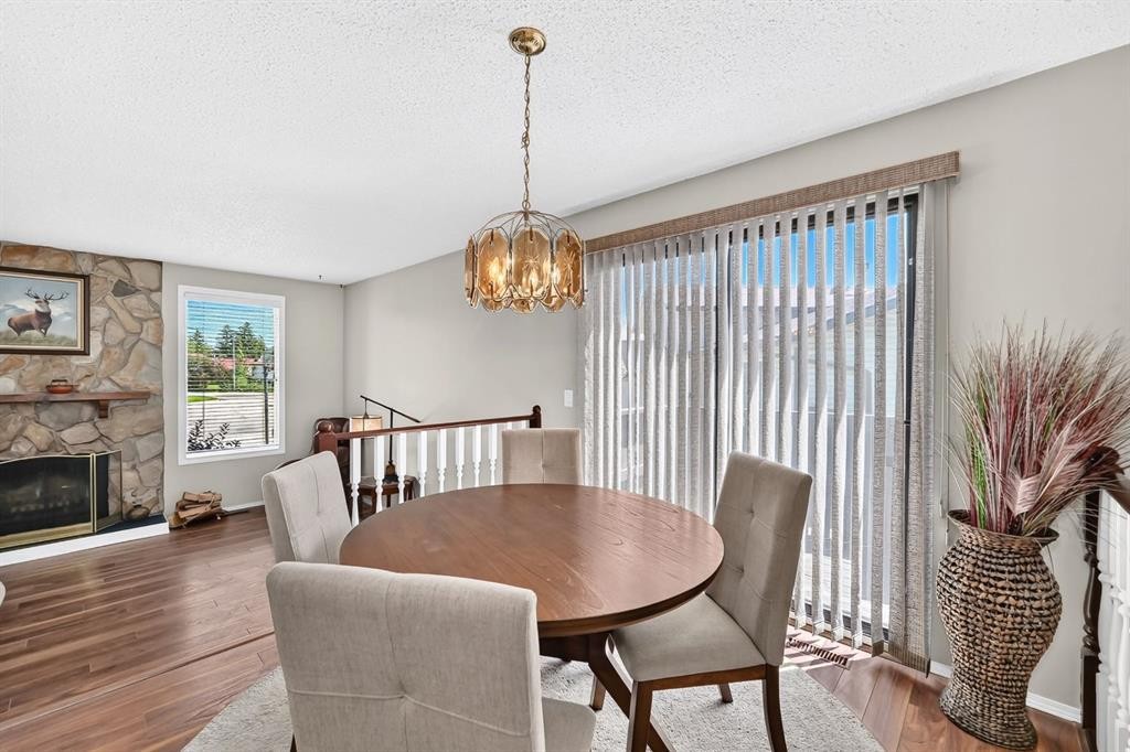 108 Falconridge Close Ne, Calgary, AB - Indoor Photo Showing Dining Room With Fireplace