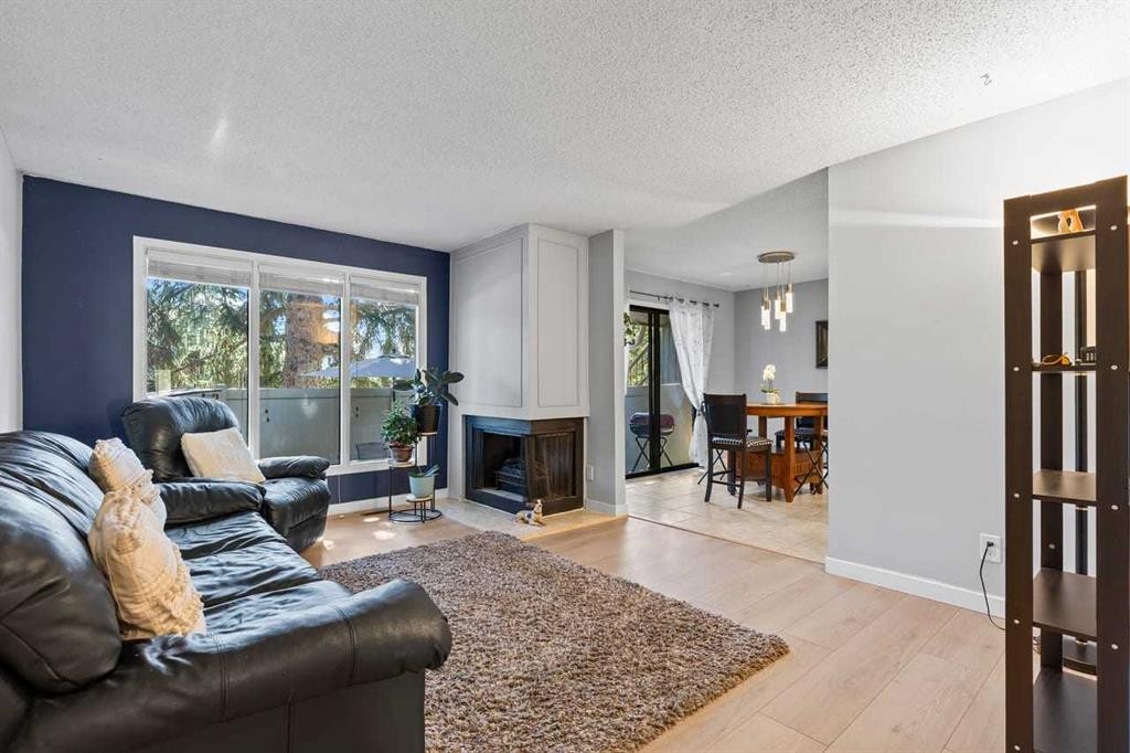 12-10001 Brookpark Boulevard Sw, Calgary, AB - Indoor Photo Showing Living Room With Fireplace
