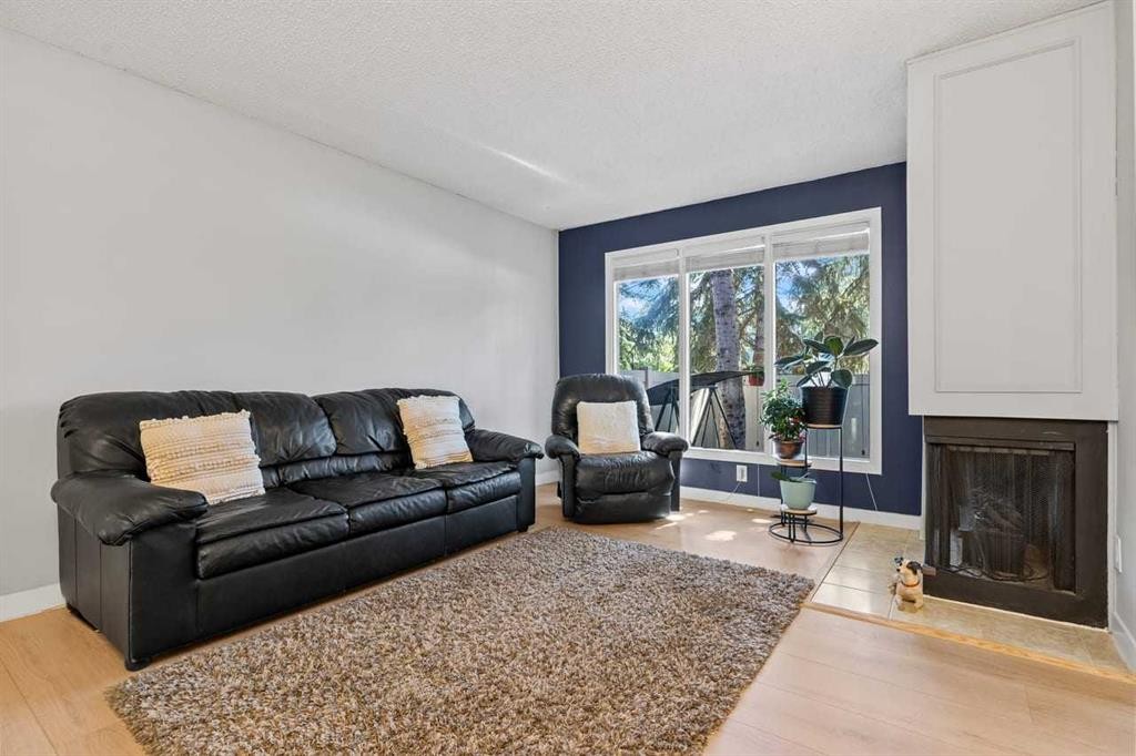 12-10001 Brookpark Boulevard Sw, Calgary, AB - Indoor Photo Showing Living Room With Fireplace