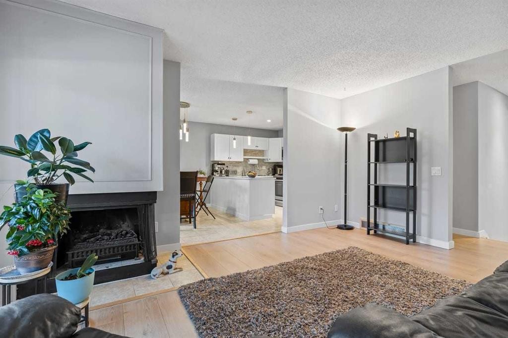 12-10001 Brookpark Boulevard Sw, Calgary, AB - Indoor Photo Showing Other Room With Fireplace